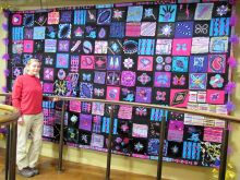 The finished Magic Carpet with the Murray Hall patches on display at Wolverhampton Grand Theatre main staircase.